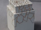 a small white box with a cracky design on it