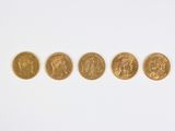 four different types of gold coins on a white surface