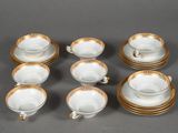 six cups and a saucer on the table