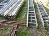 two ladders that are sitting in the grass