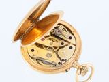 an image of a pocket watch with a chain attached to it