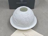 a white plate with a white bowl on it next to a black box