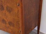 a small chest of drawers in the corner of a room