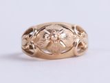 an image of a gold ring with flowers on it