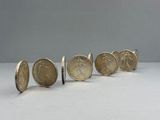 a group of five coins sitting next to each other on top of a table