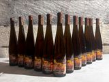 six bottles of wine are lined up in a row on a table