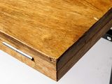 a close up of a wooden table with a drawer on it