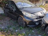 a black car that is sitting on the side of the road