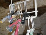 many different tools hanging from the ceiling of a room