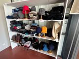 a closet with a lot of clothes and hats on the shelves