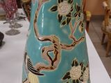 a blue vase sitting on a white table in a room