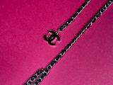 a close up of a chain on a pink surface