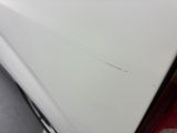 a small crack in the door of a white car