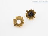 pair of gold tone flower earrings with pearl center