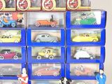 many toy cars in a display case on the table
