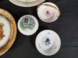 four plates and a bowl on a black table