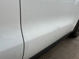 a white car that has been painted white and has a black stripe on the side of it