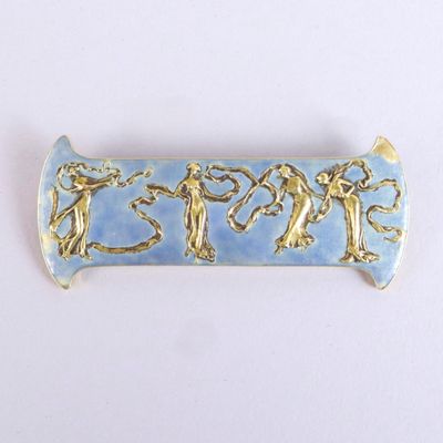 une photo d'une broche bleue et dorée ornée de personnages