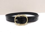a close up of a black belt with a gold buckle