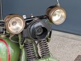 a close up of a green motorcycle parked on the street