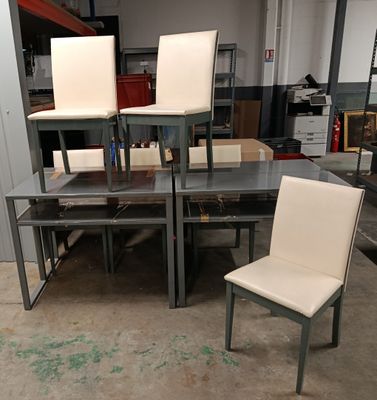several chairs and a table in a room with a lot of furniture