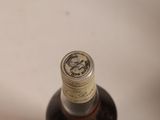 a bottle of liquor sitting on a white surface