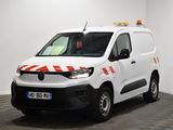 the white van is parked in a large room with a checkered floor