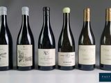 several bottles of wine are lined up on a table