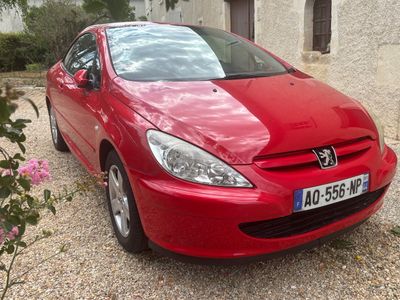 a picture of a red car parked in a driveway