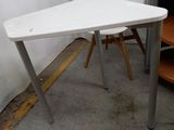 a white table and two chairs in the corner of a room