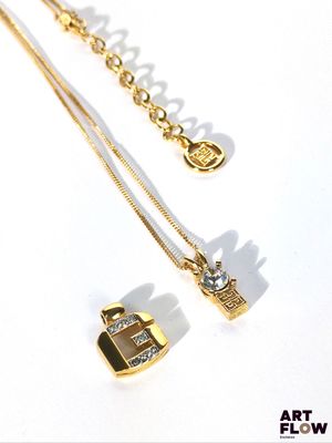 un collier en or orné d'une croix et d'un diamant