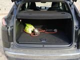 the back of a car with the trunk open and a bag in the trunk