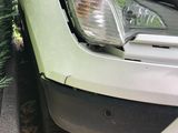 a close up of a car ' s front bumper and headlight