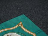 a green and gold scarf with a picture of a horse on it