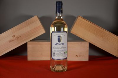 a bottle of wine sitting on a table next to a wooden box
