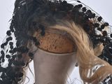 a mannequin with black and white flowers on it ' s head