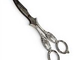 a pair of scissors sitting on top of a white surface