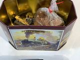 a small tin box with a picture of a train in it
