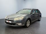 the grey citrole is parked in a room with a black floor