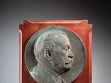 an image of a bronze plaque of a man in profile