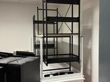 an image of a room with a computer desk and shelves