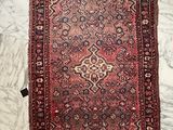 an old persian rug on a marble floor with black and white squares