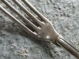 a fork that is laying on a rock on the ground