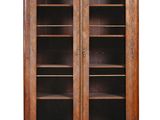 a pair of antique bookcases with glass doors on each side