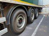 a green and yellow semi truck parked in a parking lot