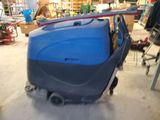 a blue machine that is sitting in the garage