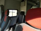 four seats in the back of a bus with a window