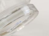 a close up of a clear glass jar with a blue label on it