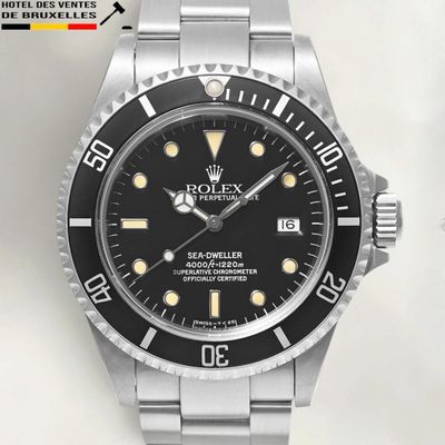 a close up of a watch with a black dial on a bracelet