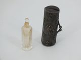 a small bottle and a small bottle on a white surface
